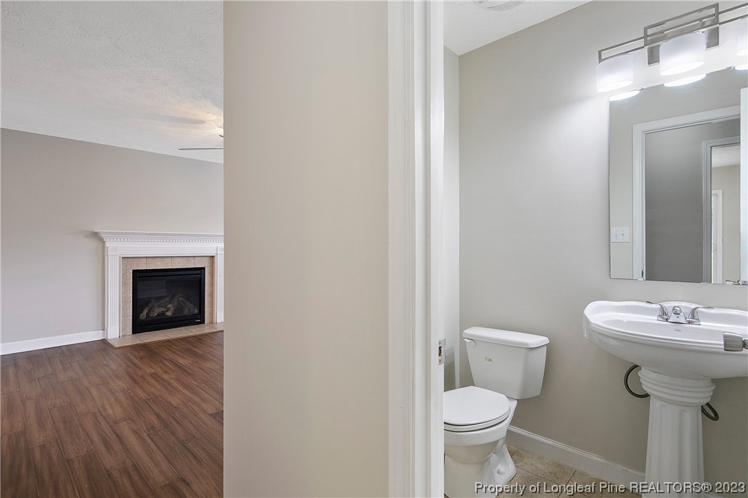 89 Rockingham Street Spring Lake, NC 28390 - Photo 18 of 41 a bathroom with a sink toilet and a mirror