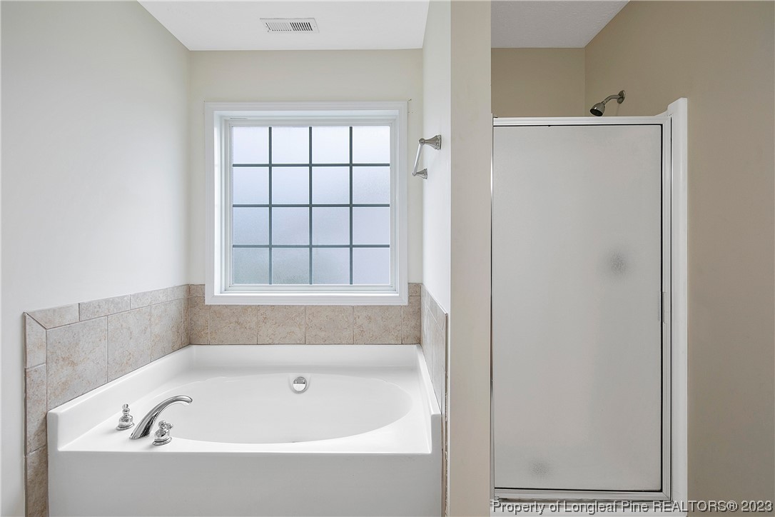 89 Rockingham Street Spring Lake, NC 28390 - Photo 23 of 41 a bathroom with bathtub and window