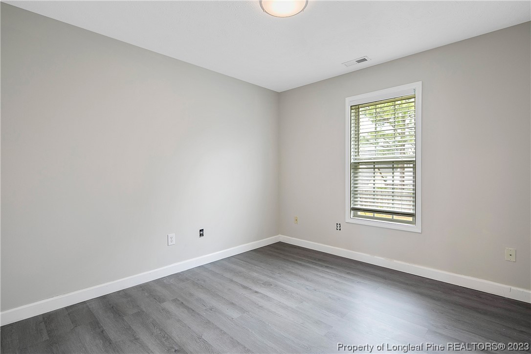 89 Rockingham Street Spring Lake, NC 28390 - Photo 24 of 41 an empty room with wooden floor and window