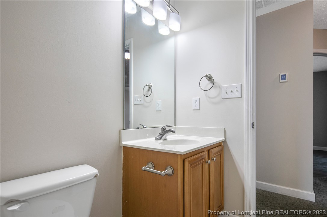 89 Rockingham Street Spring Lake, NC 28390 - Photo 29 of 41 a bathroom with a sink a toilet and a mirror