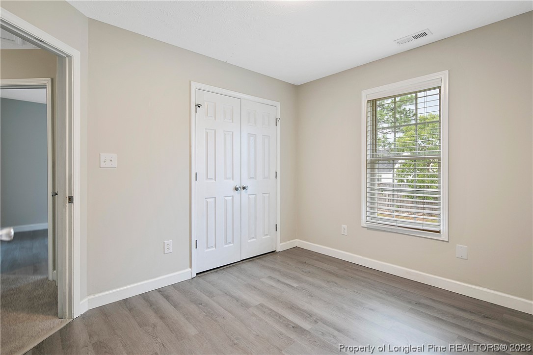 89 Rockingham Street Spring Lake, NC 28390 - Photo 33 of 41 an empty room with wooden floor and windows