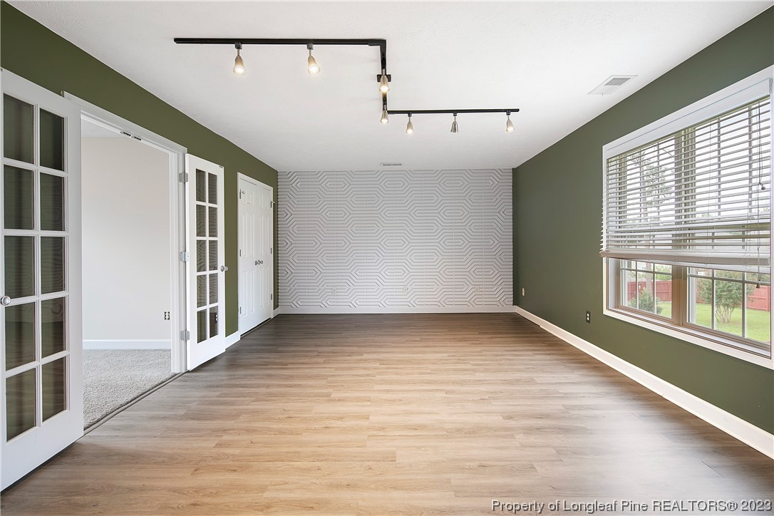 89 Rockingham Street Spring Lake, NC 28390 - Photo 34 of 41 an empty room with wooden floor and windows