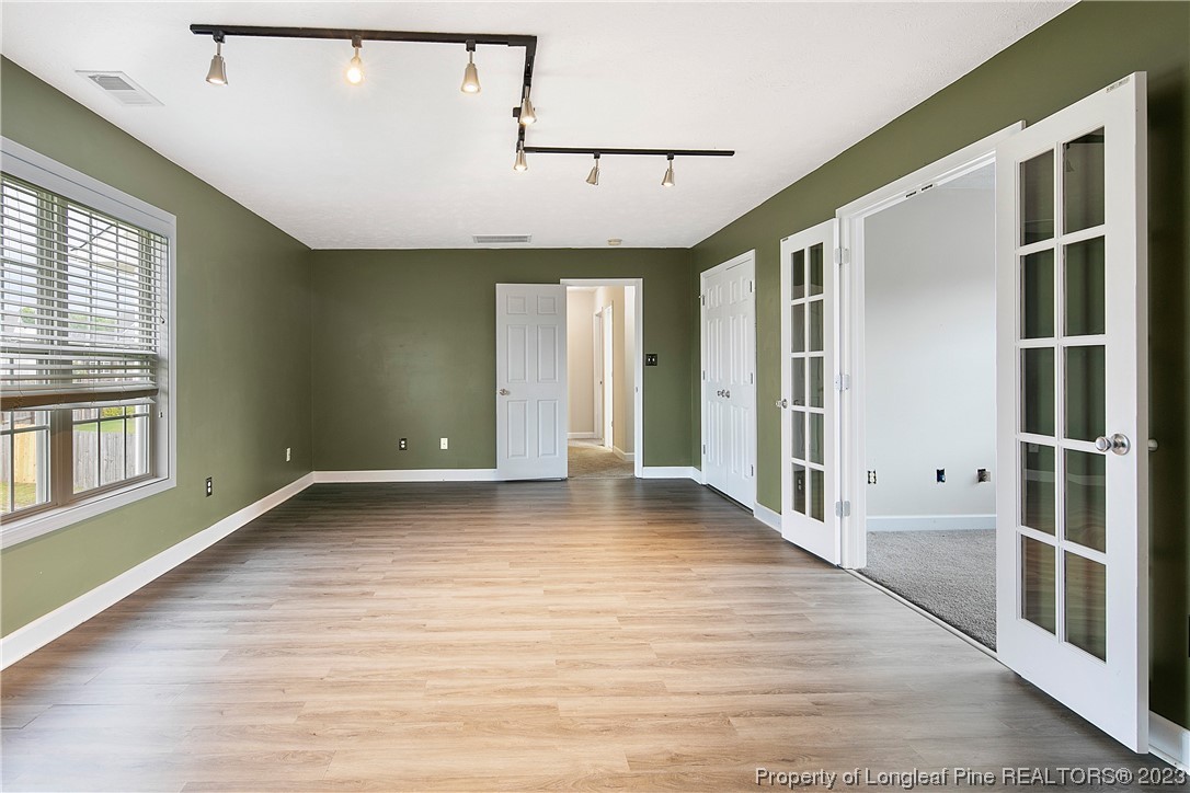 89 Rockingham Street Spring Lake, NC 28390 - Photo 36 of 41 a view of a livingroom with wooden floor and a ceiling fan