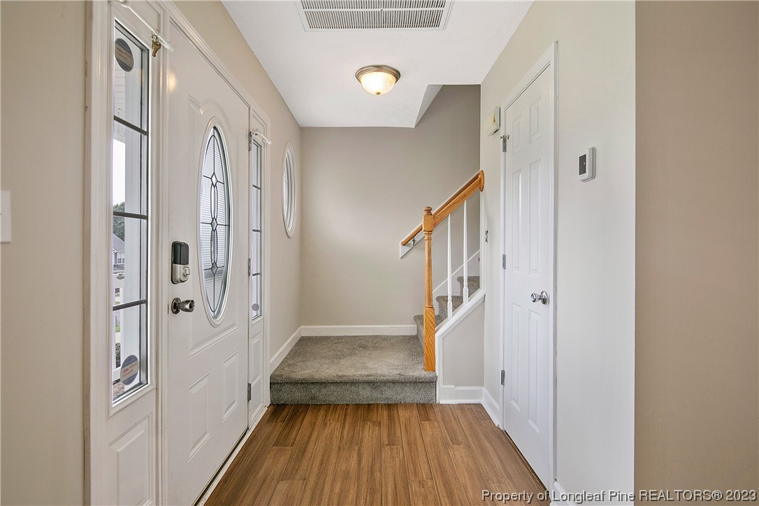 89 Rockingham Street Spring Lake, NC 28390 - Photo 5 of 41 a view of a hallway view with wooden floor and staircase