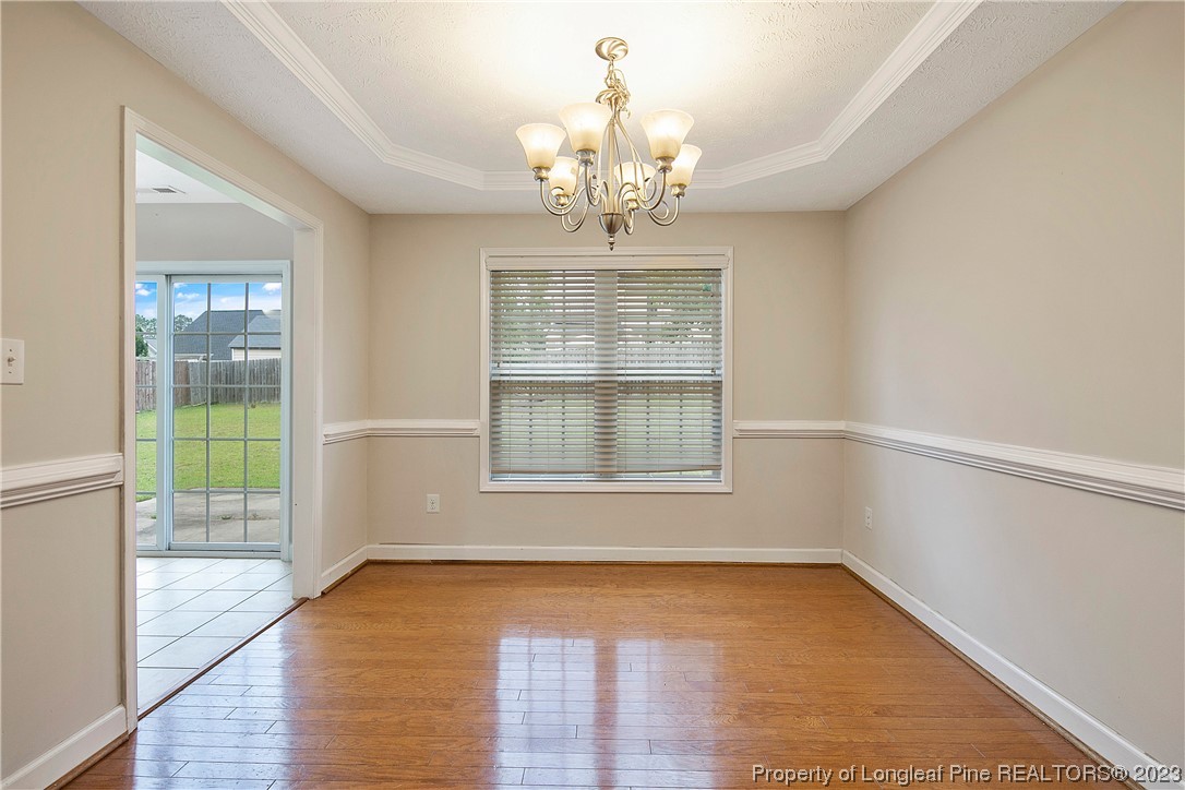 89 Rockingham Street Spring Lake, NC 28390 - Photo 9 of 41 a view of an empty room with wooden floor and a window