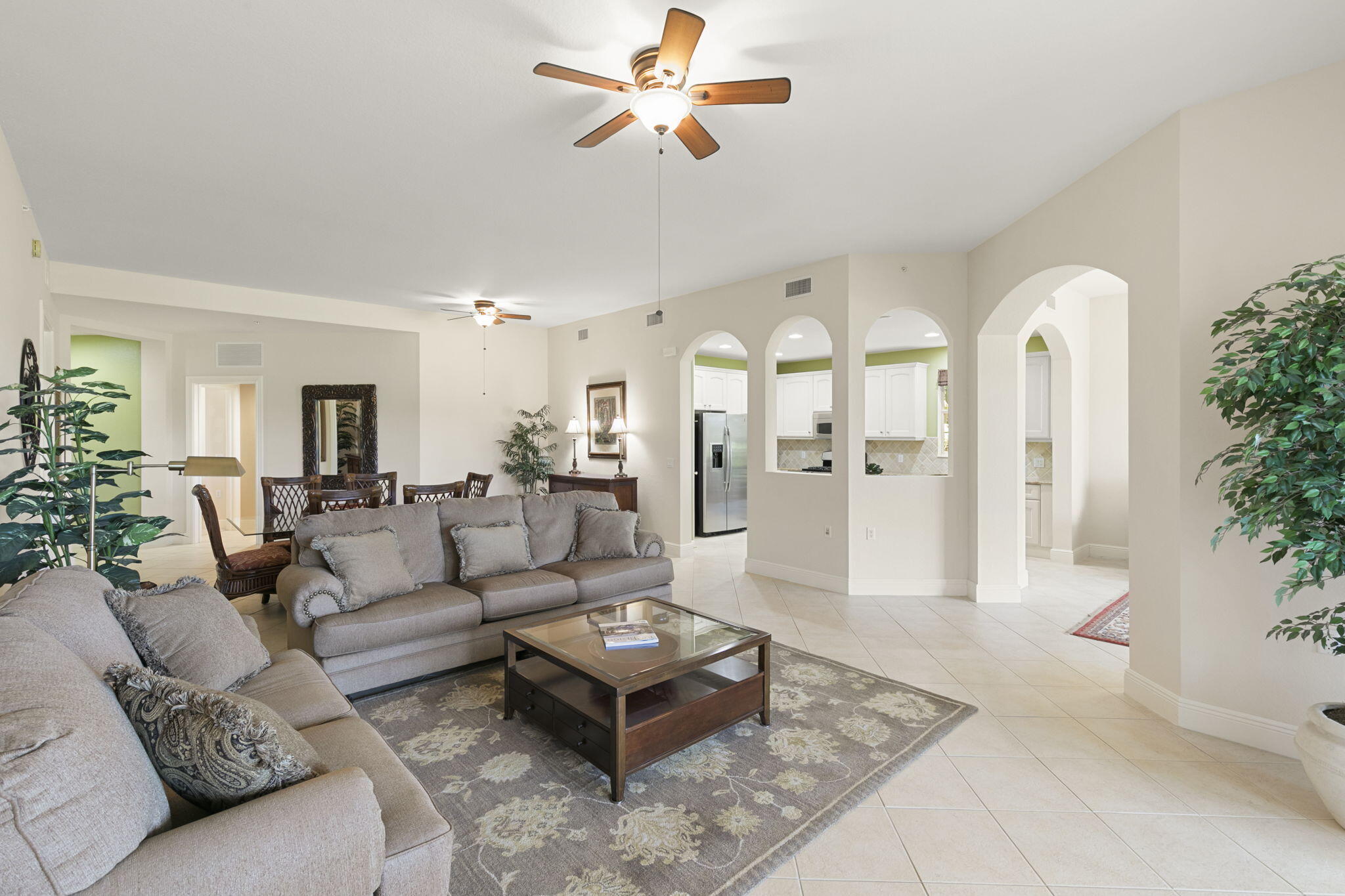 9066 Cascada Way, Unit 101 Naples, FL 34114 - Photo 9 of 51 a living room with furniture dining table and a chandelier