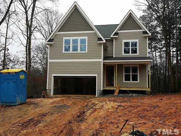5308 Olive Road Raleigh, NC 27606 - Photo 1 of 6 a front view of a house with a yard and garage