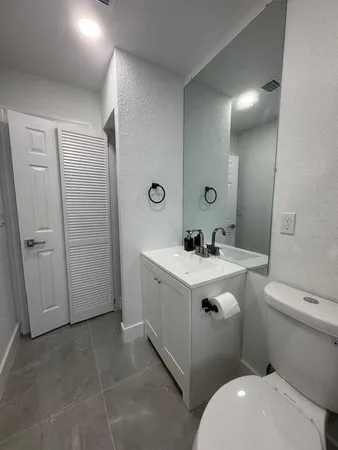 a bedroom with a bed and a mirror