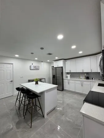 a living room with a bed and a cabinets