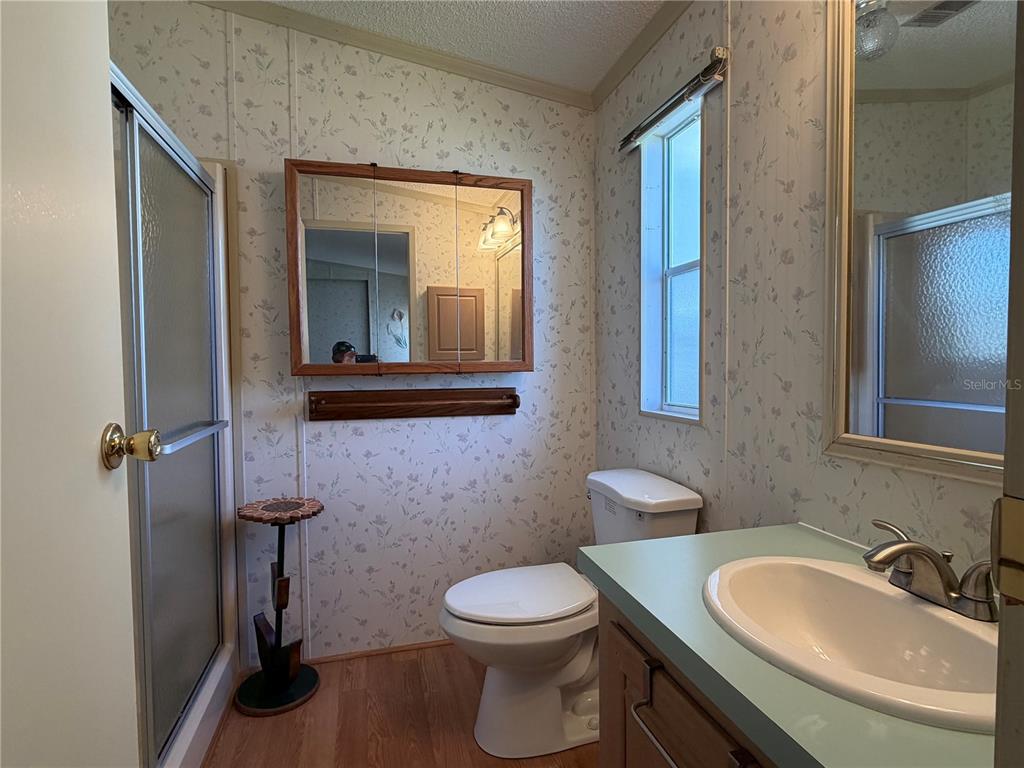208 Eagle Punta Gorda, FL 33950 - Photo 13 of 16 a bathroom with a toilet a sink and mirror