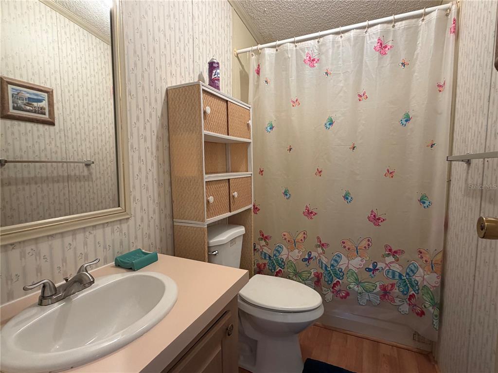 208 Eagle Punta Gorda, FL 33950 - Photo 15 of 16 a bathroom with a sink a toilet and shower curtain