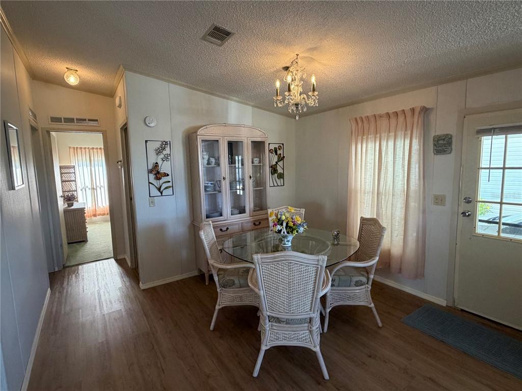 208 Eagle Punta Gorda, FL 33950 - Photo 6 of 16 a view of a dining room with furniture wooden floor and chandelier