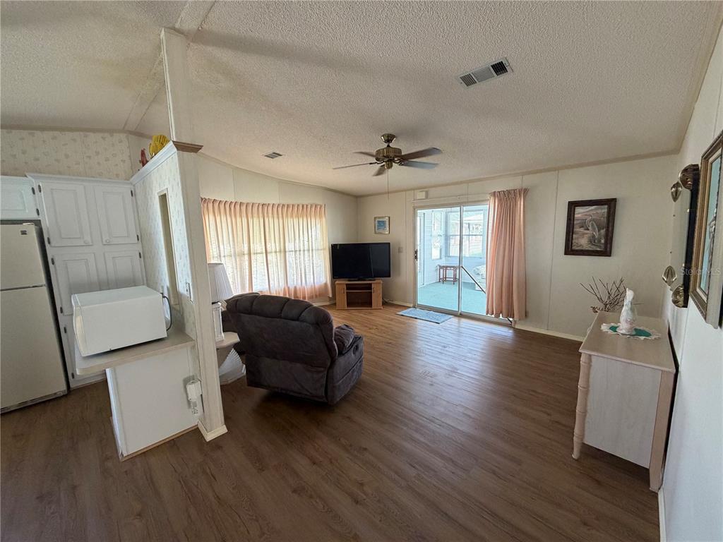 208 Eagle Punta Gorda, FL 33950 - Photo 7 of 16 a living room with furniture and a flat screen tv