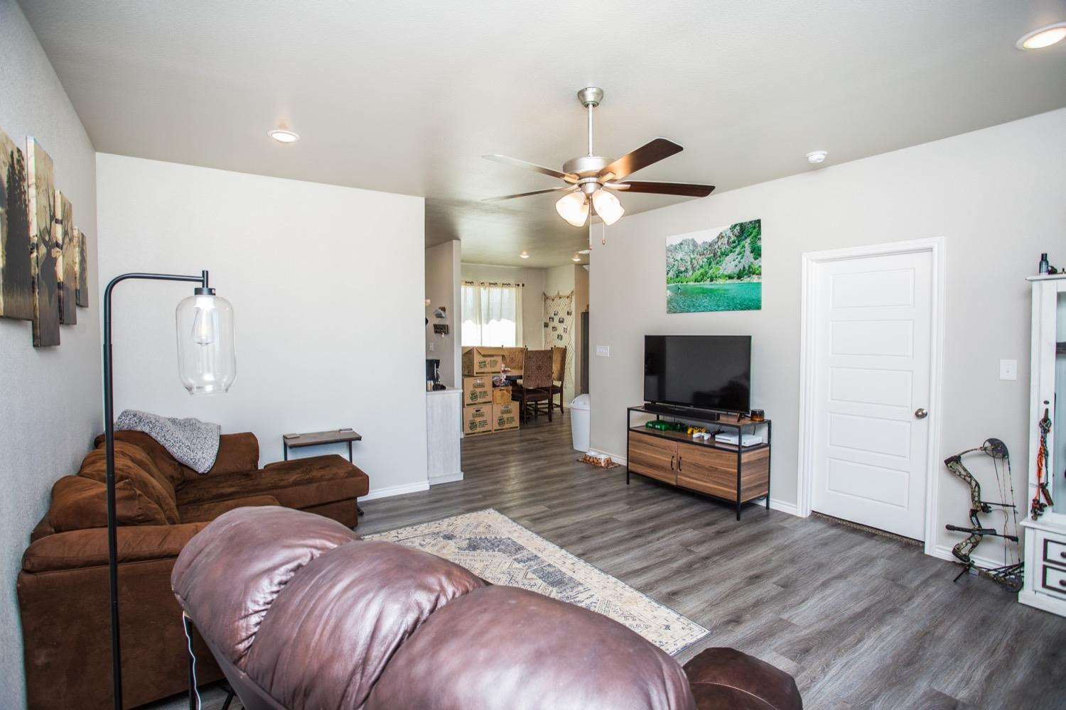 7004 10th Street Lubbock, TX 79416 - Photo 11 of 32 a living room with furniture and a flat screen tv