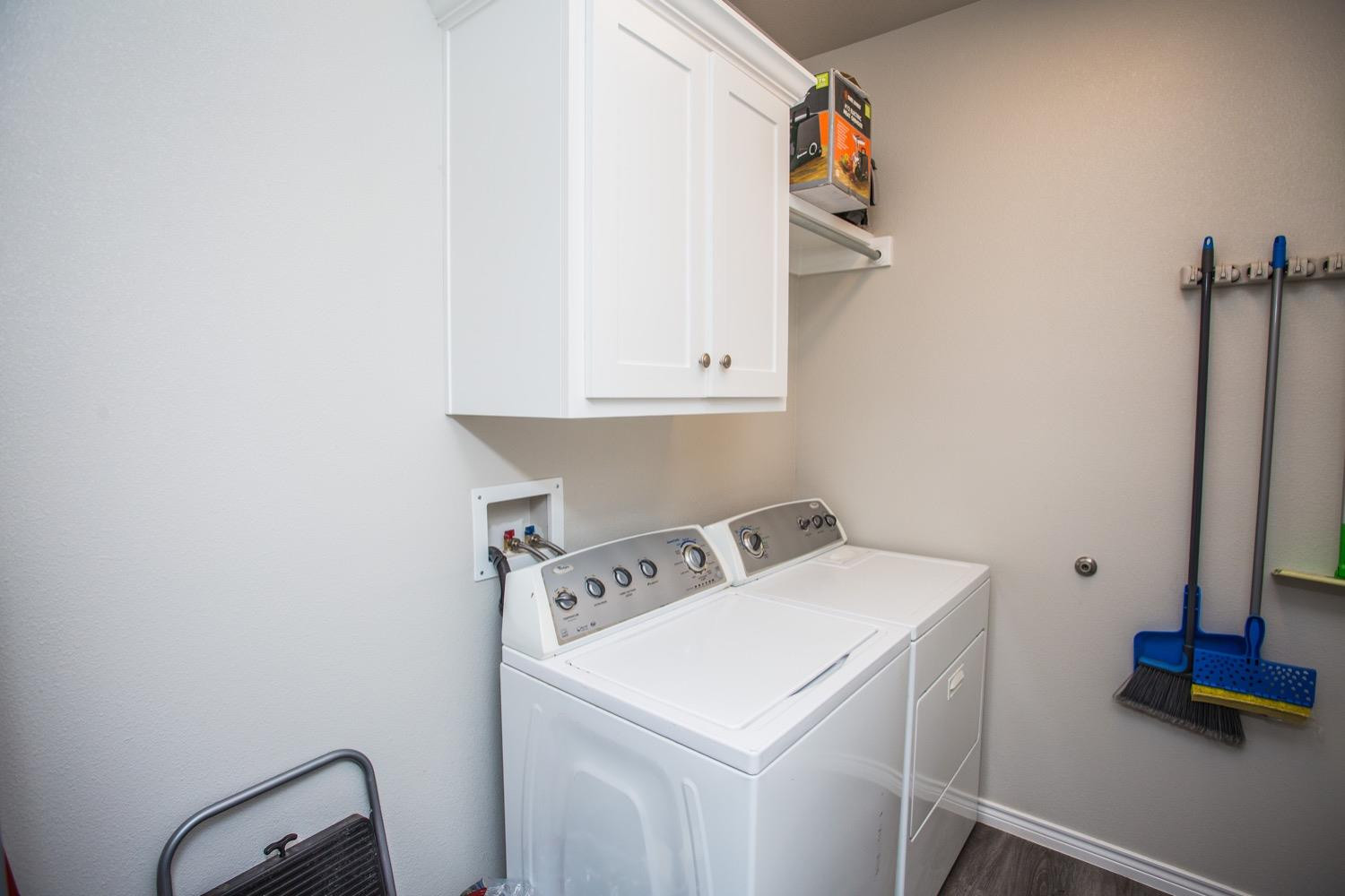7004 10th Street Lubbock, TX 79416 - Photo 16 of 32 a utility room with dryer and washer