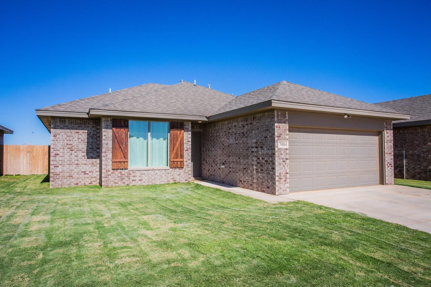 7004 10th Street Lubbock, TX 79416 - Photo 2 of 32 a front view of a house with a yard