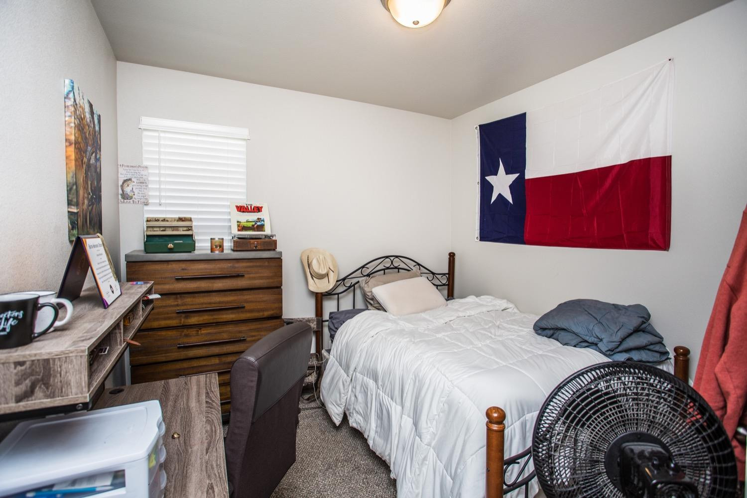 7004 10th Street Lubbock, TX 79416 - Photo 21 of 32 a bedroom with two beds and a dresser
