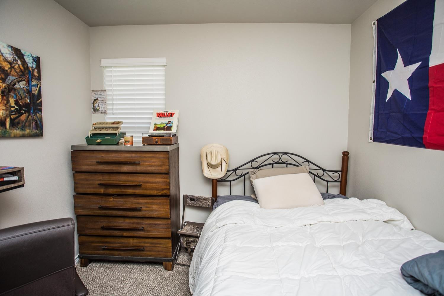 7004 10th Street Lubbock, TX 79416 - Photo 22 of 32 a bedroom with a bed and a window