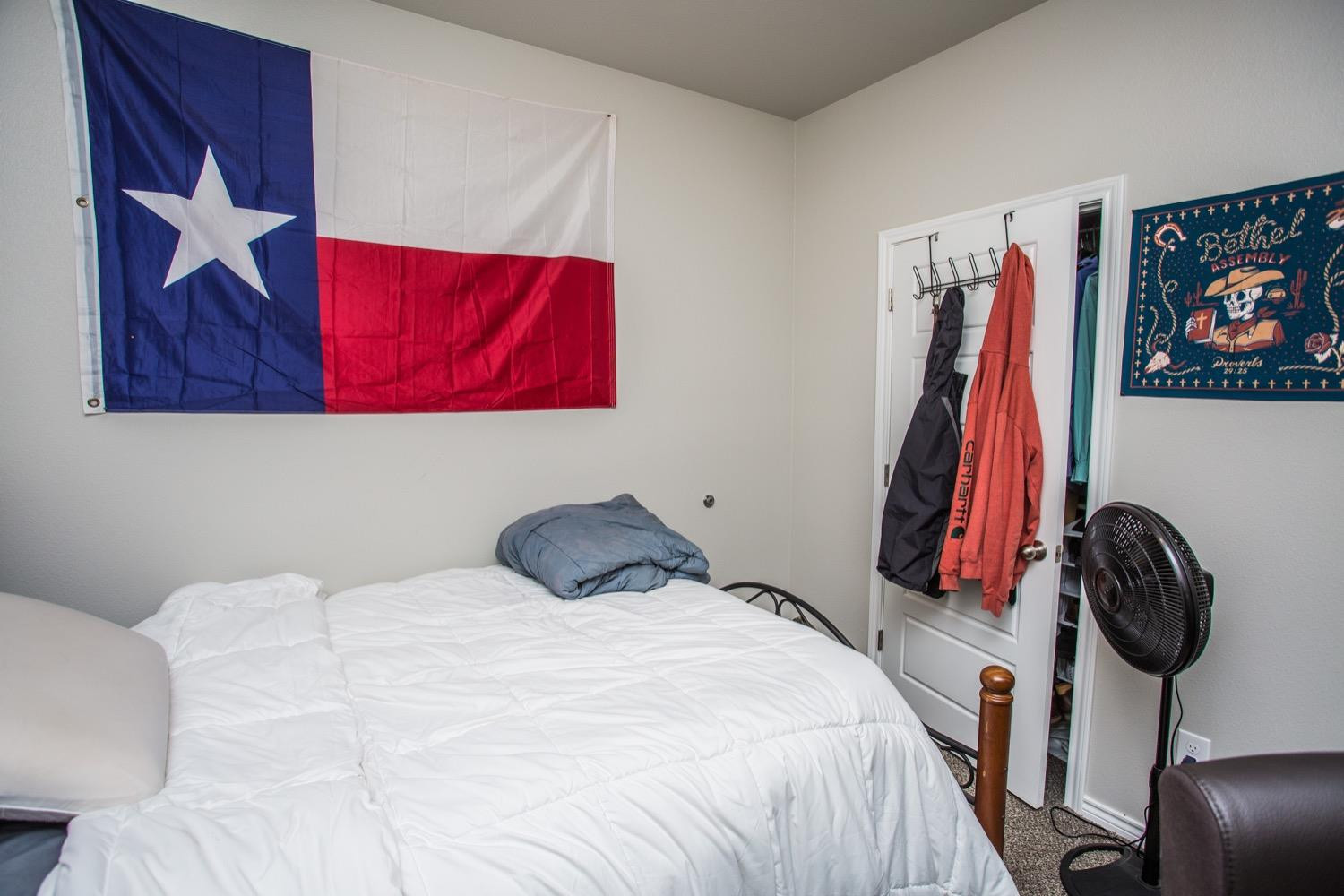 7004 10th Street Lubbock, TX 79416 - Photo 23 of 32 a bedroom with a bed and a wall painting