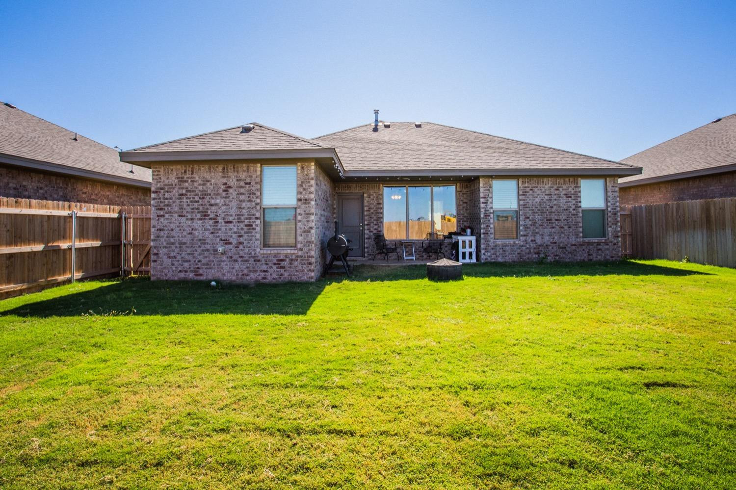 7004 10th Street Lubbock, TX 79416 - Photo 32 of 32 a front view of a house with a yard table and chairs