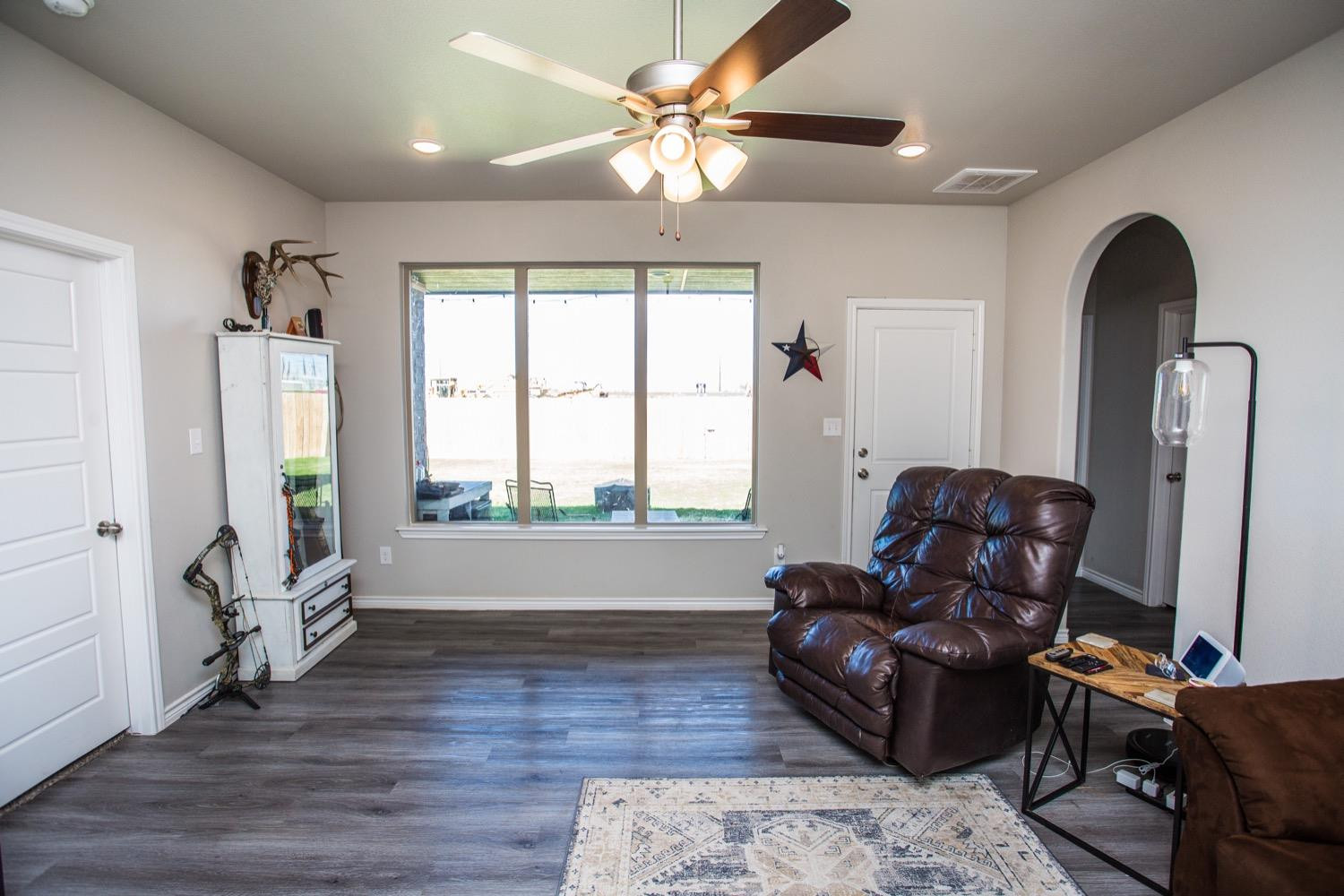 7004 10th Street Lubbock, TX 79416 - Photo 8 of 32 a living room with furniture and wooden floor