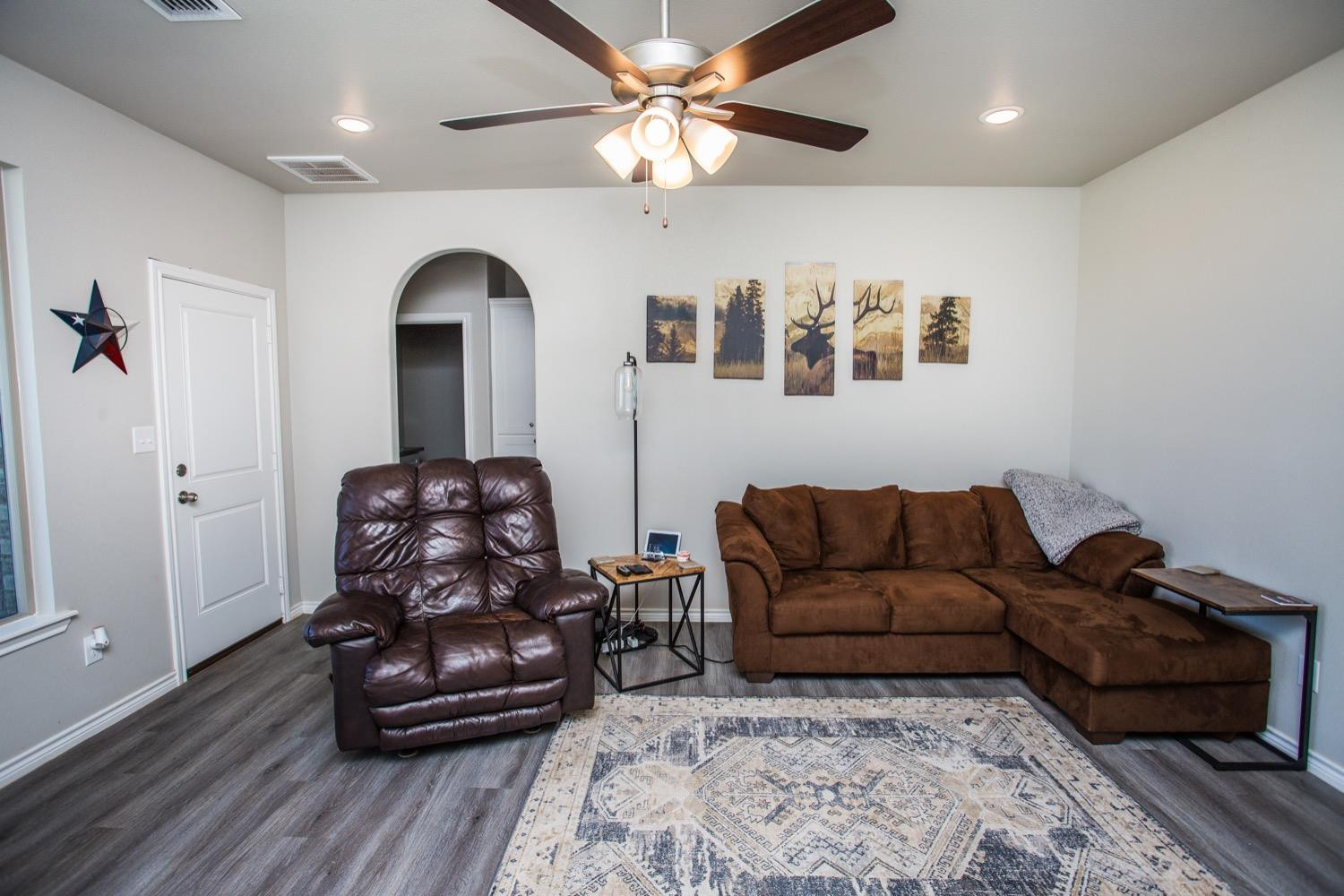 7004 10th Street Lubbock, TX 79416 - Photo 9 of 32 a living room with furniture and a wooden floor
