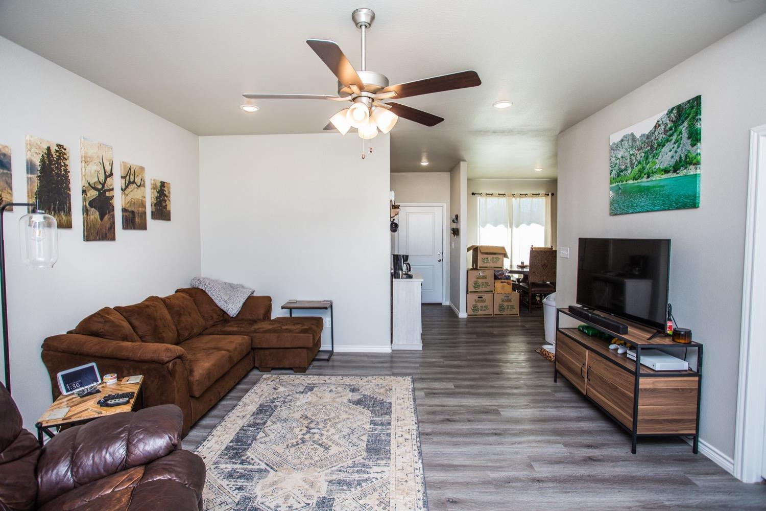 7004 10th Street Lubbock, TX 79416 - Photo 10 of 32 a living room with furniture and a flat screen tv