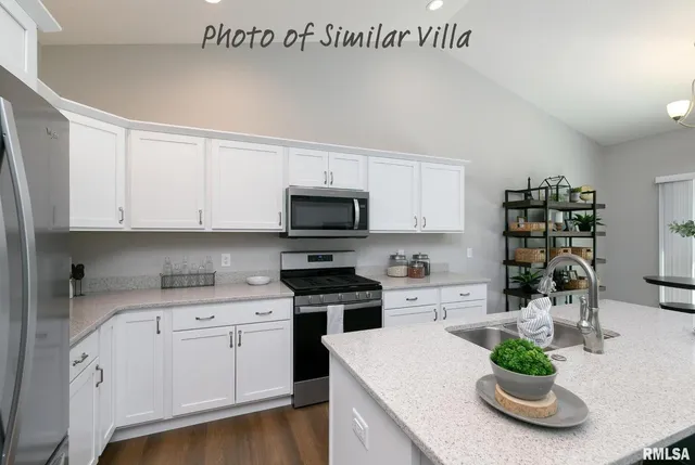 a kitchen with stainless steel appliances granite countertop a sink a stove and cabinets