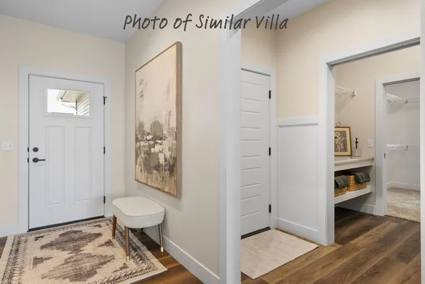 a view of a bedroom with wooden floor and furniture