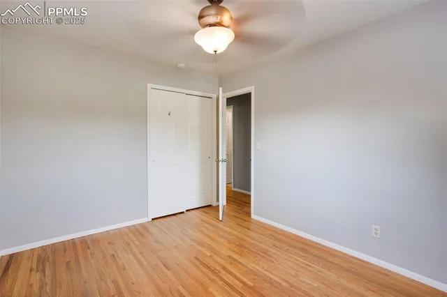 a view of empty room with wooden floor
