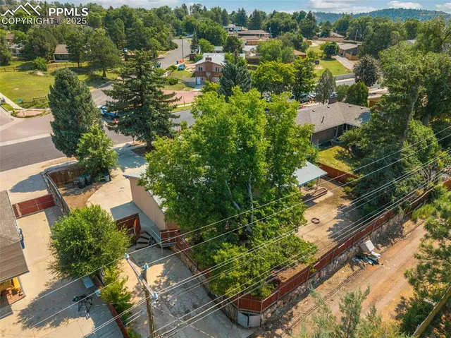 an aerial view of residential houses with outdoor space and swimming pool