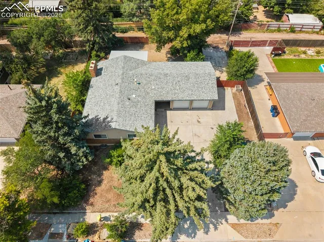 an aerial view of a house with a garden and swimming pool
