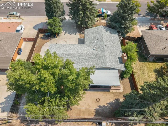 an aerial view of a house with a yard and garden