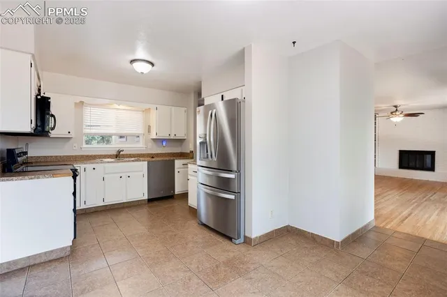 a kitchen with stainless steel appliances a refrigerator sink and microwave