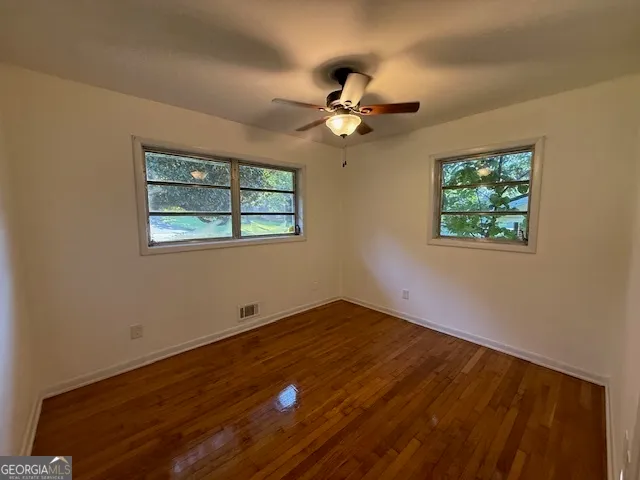 a view of room with window and ceiling fan