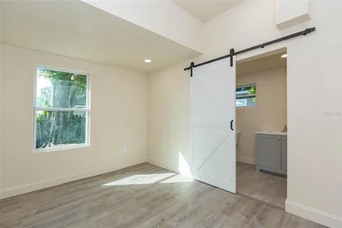 an empty room with windows and closet