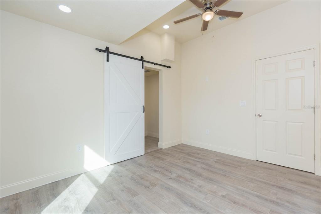 3008 North 17th Street Tampa, FL 33605 - Photo 15 of 28 a view of a room with a ceiling fan and wooden floor