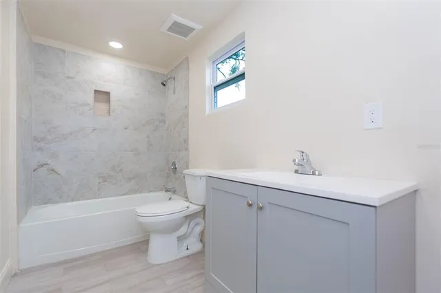 a bathroom with a sink a toilet and a bathtub