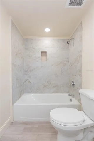 a bathroom with a toilet and a bathtub