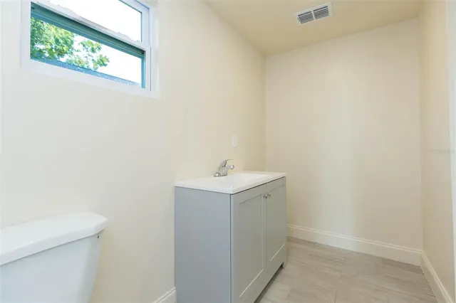 a bathroom with a sink a vanity and window