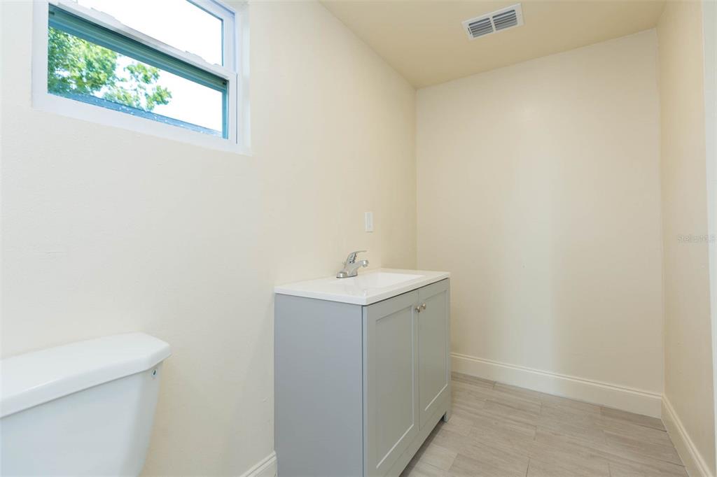 3008 North 17th Street Tampa, FL 33605 - Photo 18 of 28 a bathroom with a sink a vanity and window