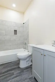 a bathroom with a toilet a sink and bathtub