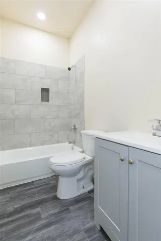 a bathroom with a toilet a sink and bathtub