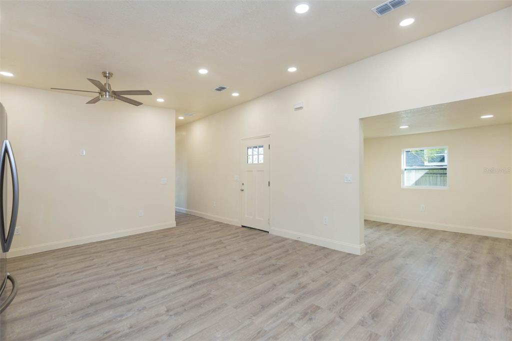 3008 North 17th Street Tampa, FL 33605 - Photo 5 of 28 an empty room with wooden floor fan and windows