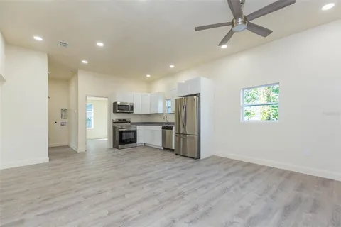 a view of kitchen with stainless steel appliances a refrigerator and a microwave