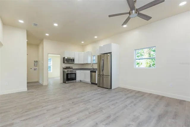 a view of kitchen with stainless steel appliances a refrigerator and a microwave