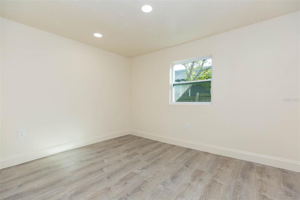 3008 North 17th Street Tampa, FL 33605 - Photo 9 of 28 an empty room with wooden floor and windows