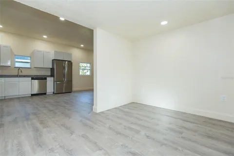 a view of a kitchen with a sink and a refrigerator