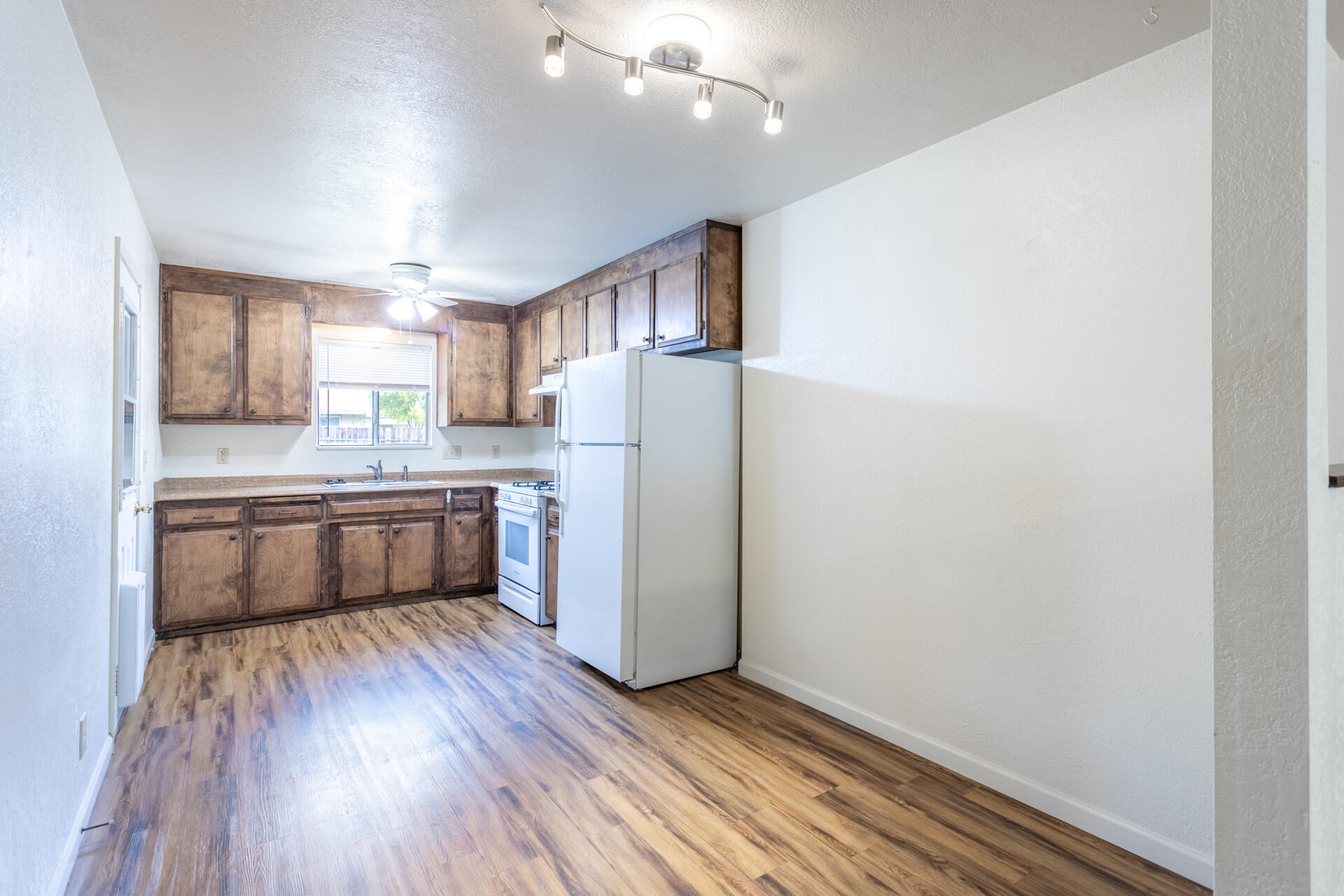2472 Saturn Redding, CA 96002 - Photo 3 of 15 a kitchen with a refrigerator and a stove top oven