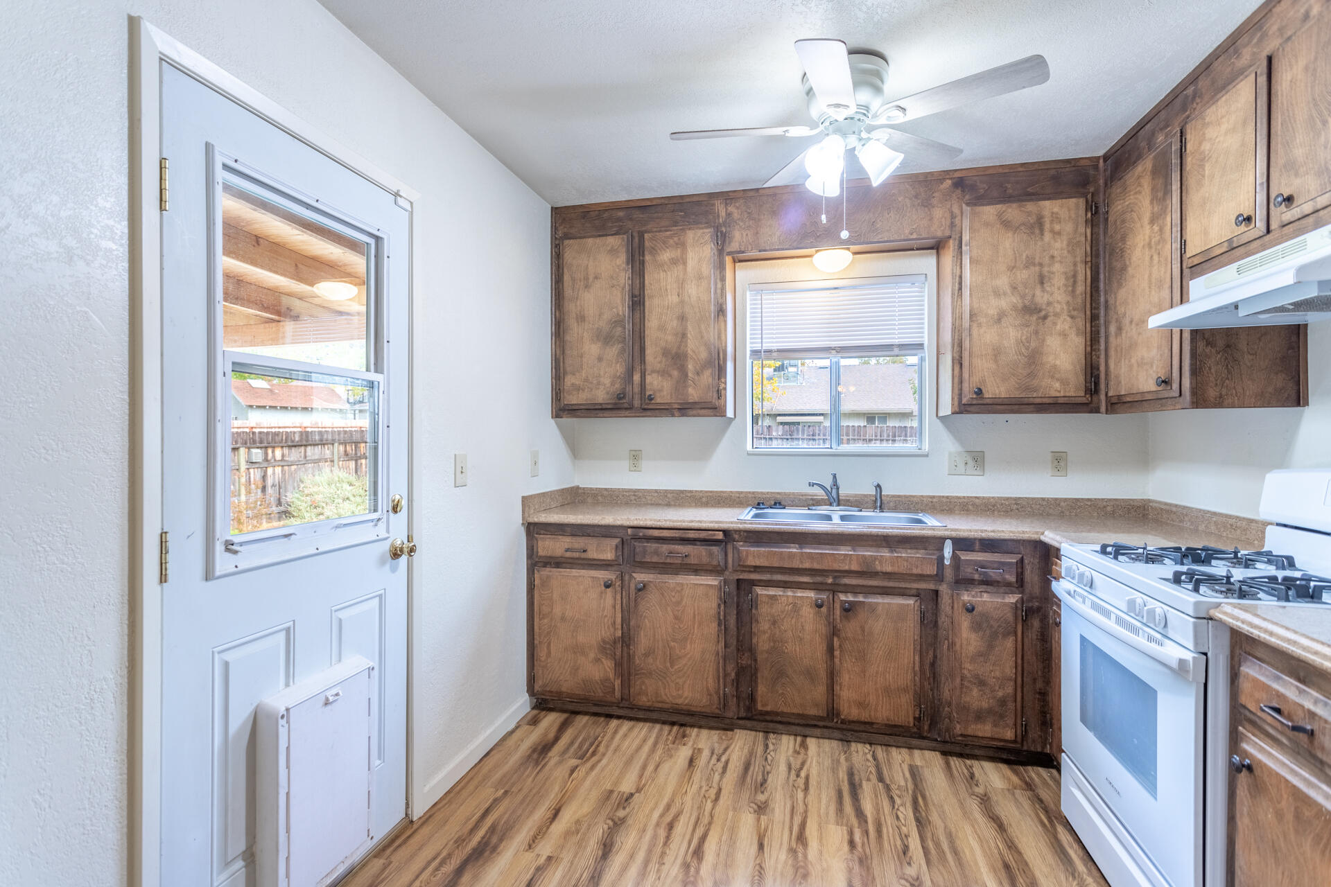 2472 Saturn Redding, CA 96002 - Photo 4 of 15 a kitchen with a sink window and cabinets